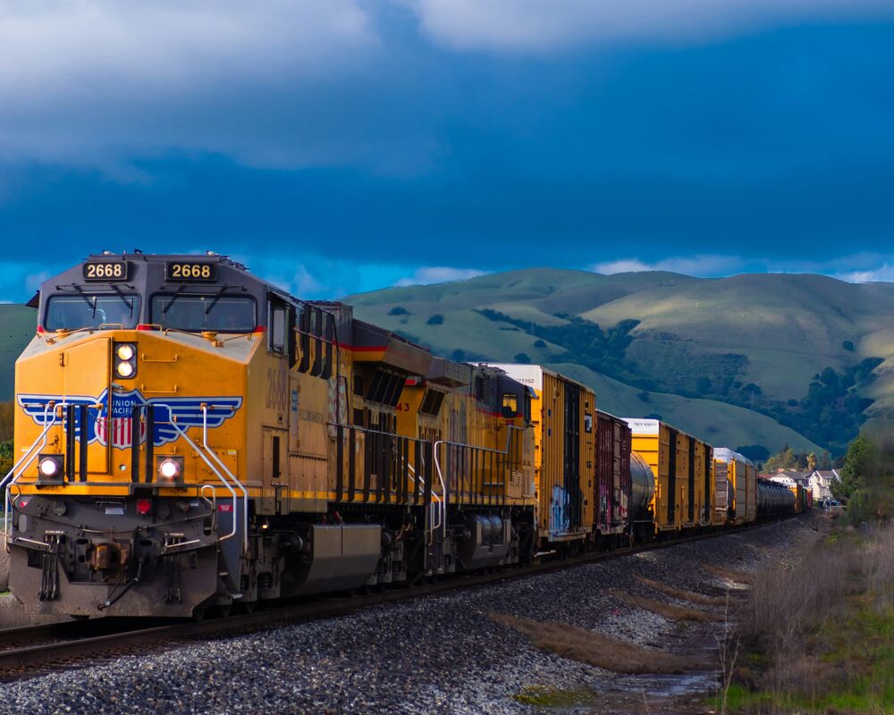 Freight train hauling cargo along the rail corridor